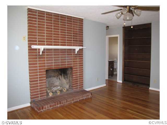 467 Crymes Orchard Road Keysville, VA 23947 - Photo 6 of 13 a view of an empty room with wooden floor and a fireplace
