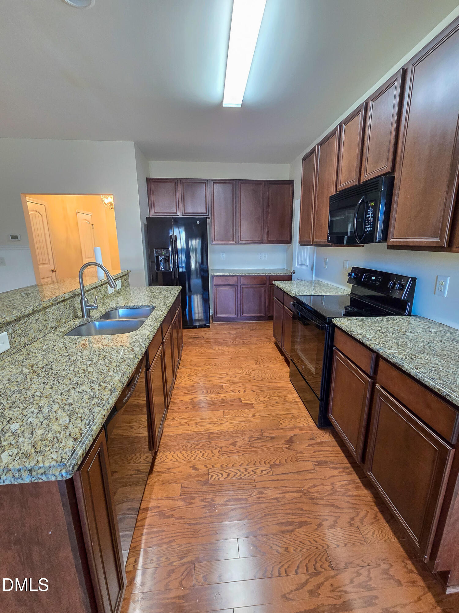 4609 Pat Reed Road Raleigh, NC 27616 - Photo 11 of 42 a kitchen with stainless steel appliances granite countertop a sink stove and refrigerator
