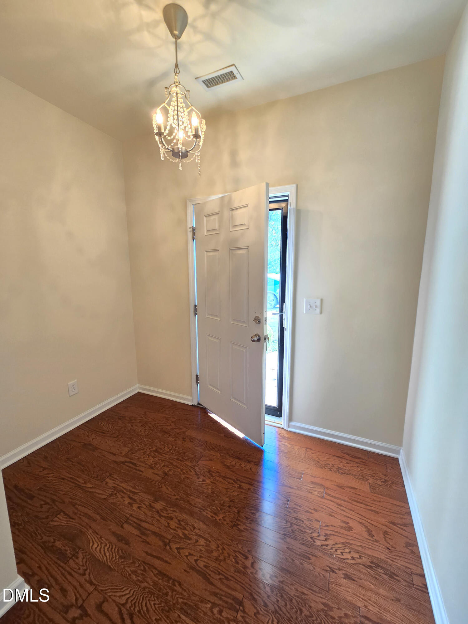 4609 Pat Reed Road Raleigh, NC 27616 - Photo 4 of 42 a view of a chandelier in big room with wooden floor