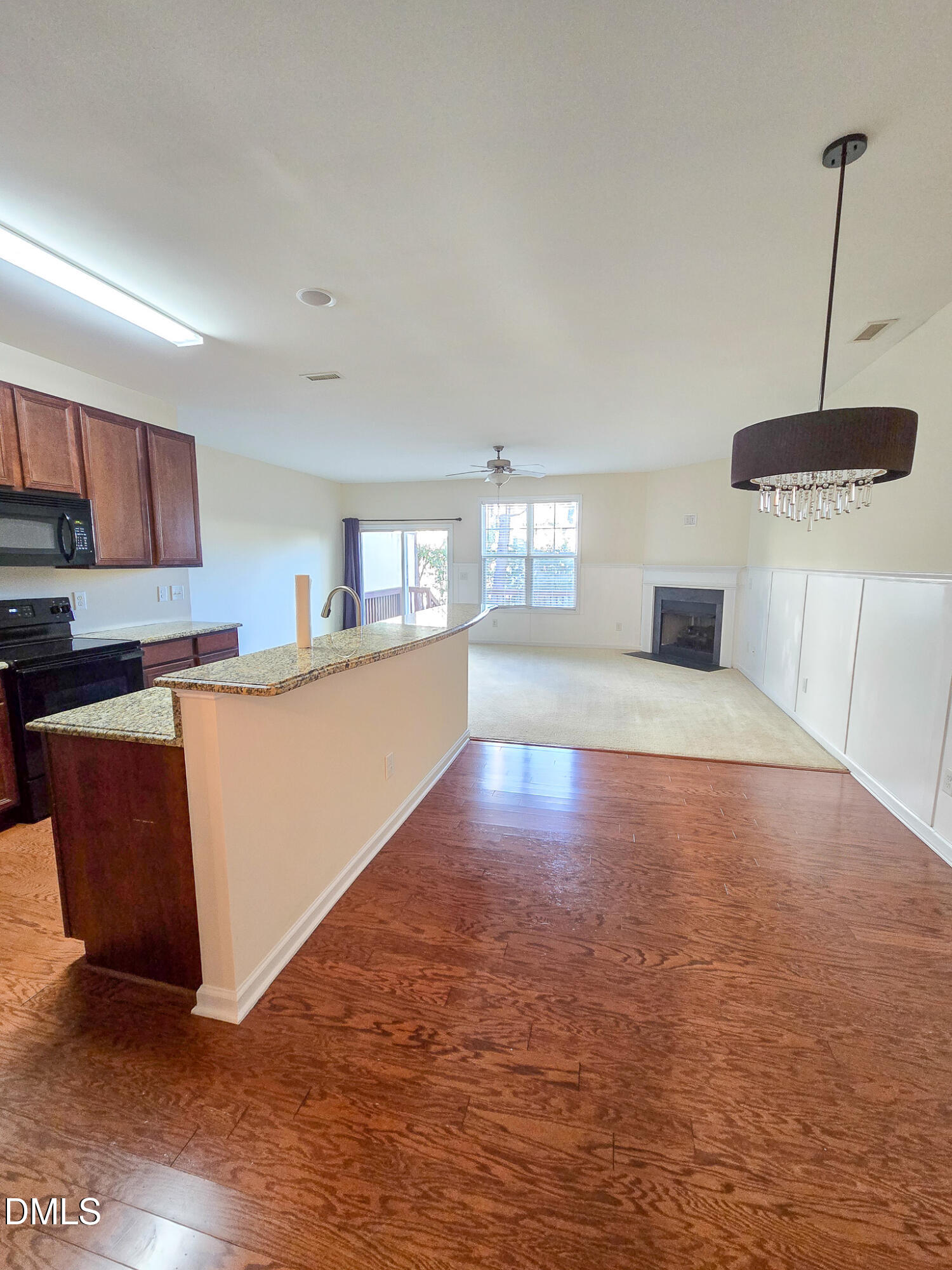 4609 Pat Reed Road Raleigh, NC 27616 - Photo 8 of 42 a large kitchen with stainless steel appliances granite countertop a stove a sink a refrigerator white cabinets and wooden floor