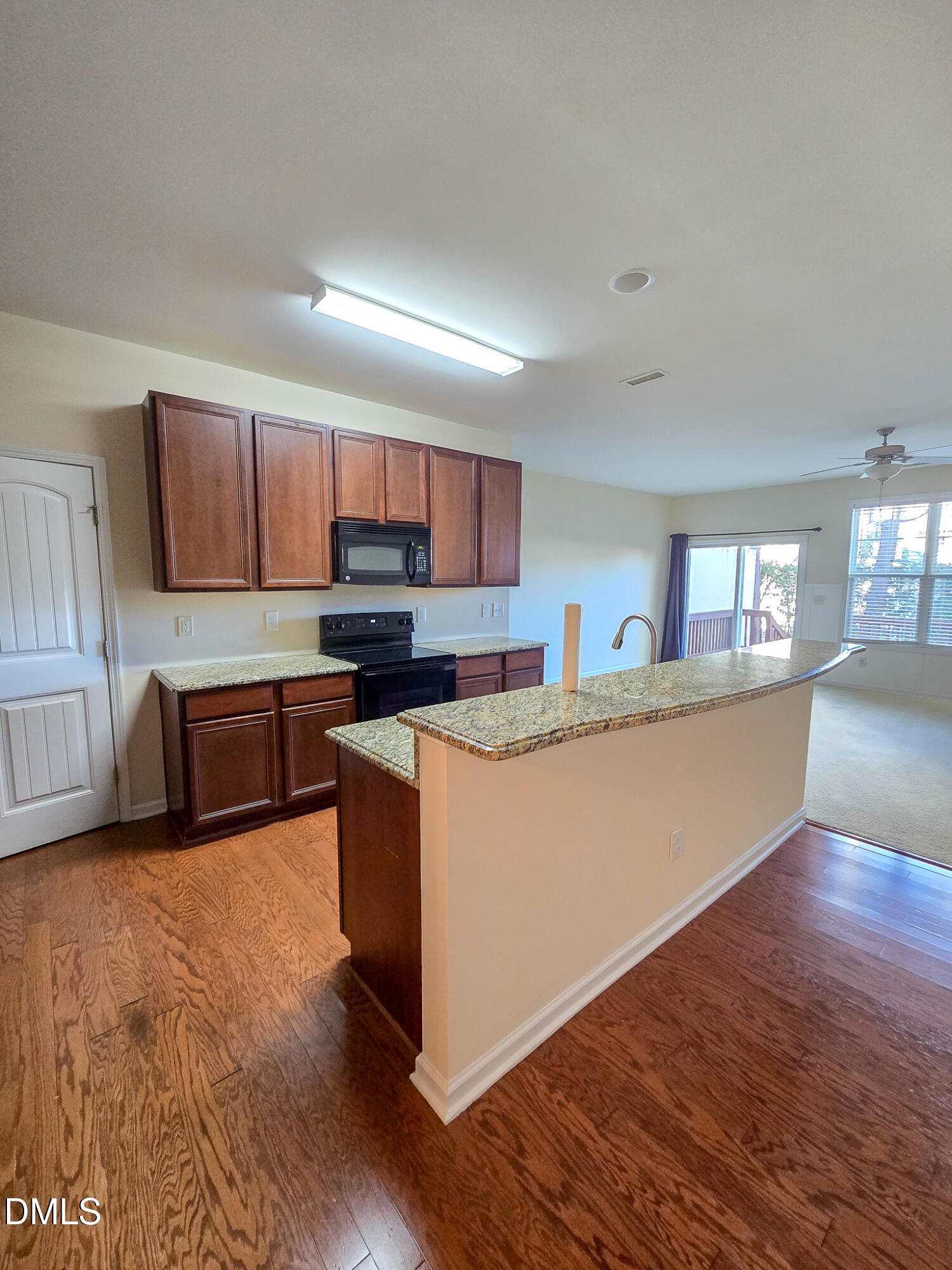 4609 Pat Reed Road Raleigh, NC 27616 - Photo 9 of 42 a large kitchen with stainless steel appliances granite countertop a stove a sink a refrigerator and a granite countertops with wooden floor