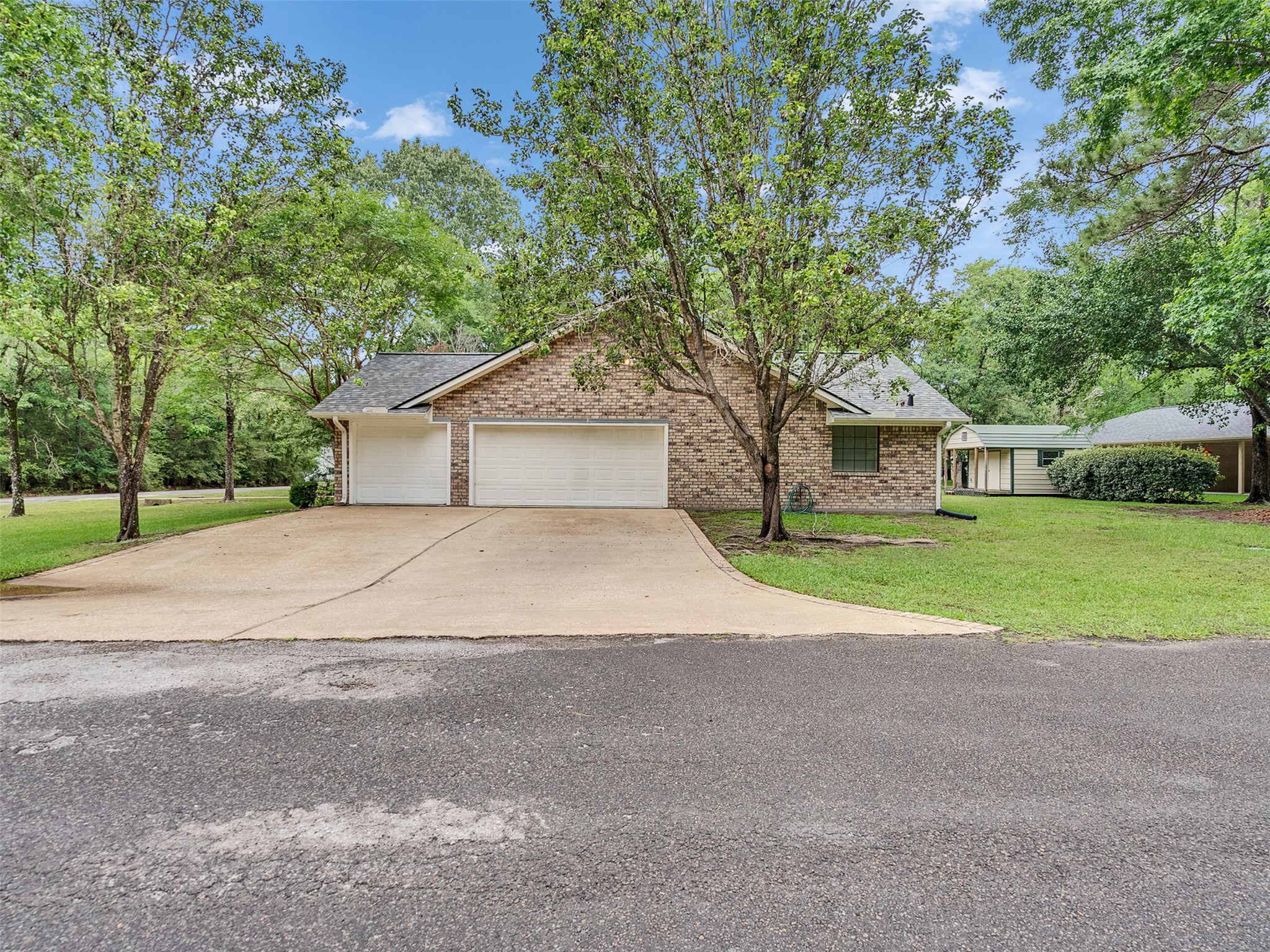 195 Coral Gables Trinity, TX 75862 - Photo 44 of 50 a house with tree in front of it