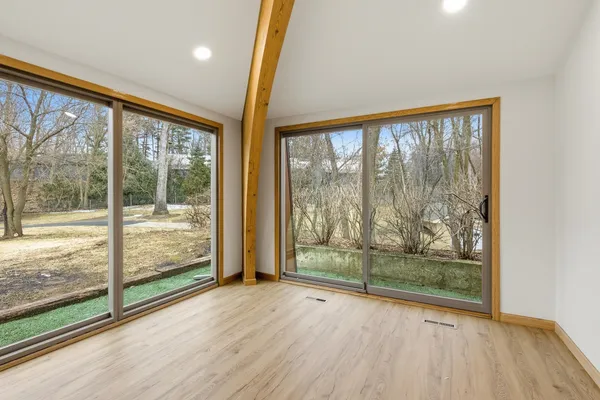 a view of a room with wooden floor and doors