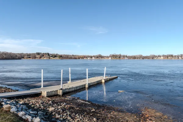 a wooden bench sitting next to a lake