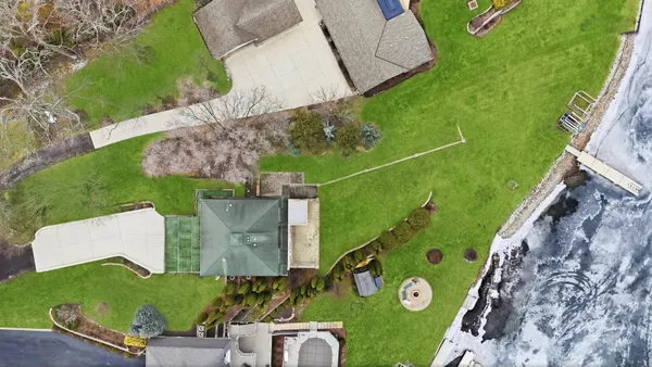 a view of a house with a yard and sitting area