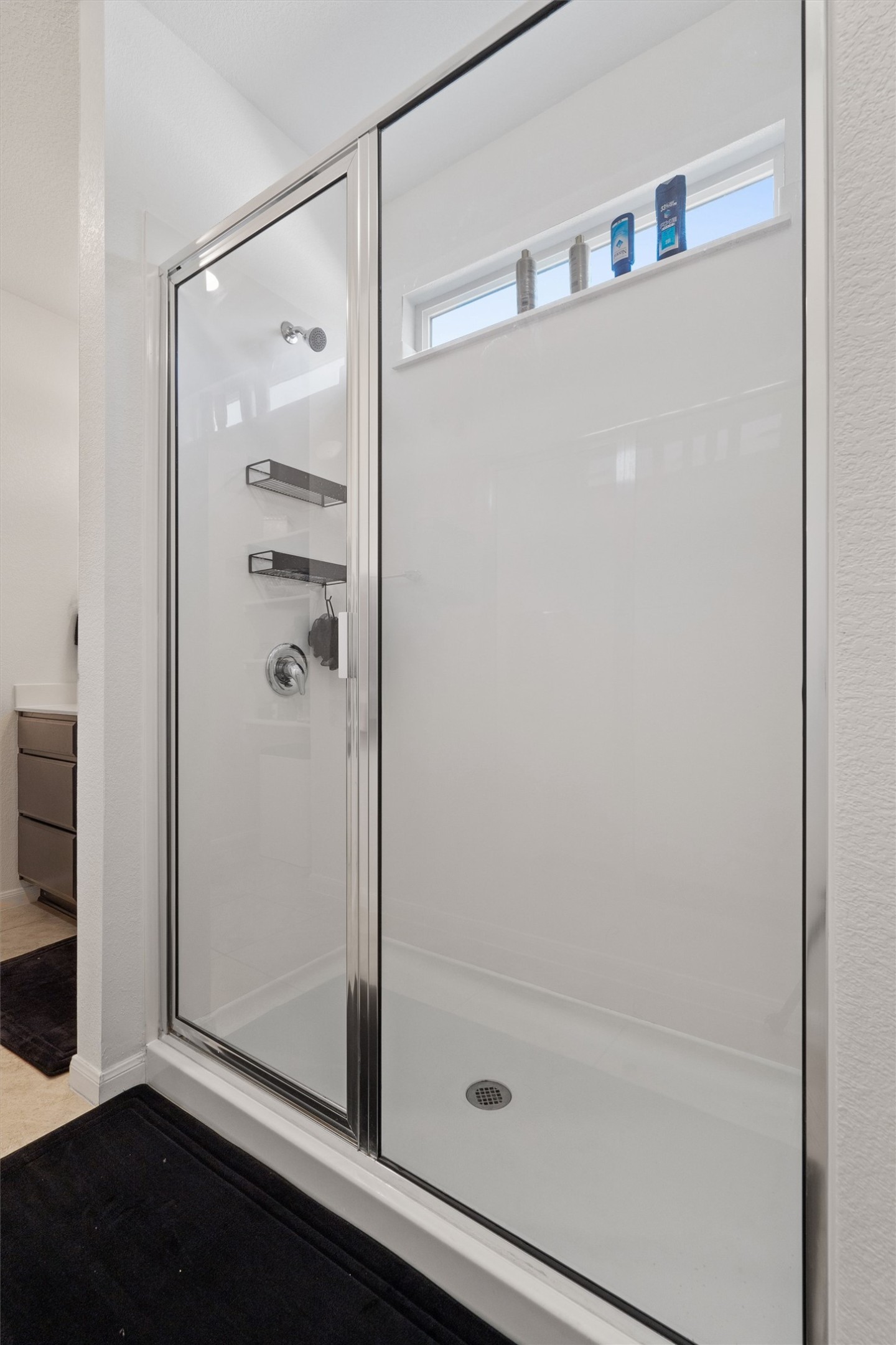 10308 Hatton Lane Austin, TX 78754 - Photo 12 of 25 Glass-enclosed walk-in shower with clean lines and bright finishes for a modern, refreshed feel