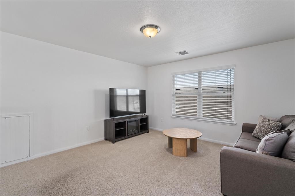 10308 Hatton Lane Austin, TX 78754 - Photo 15 of 25 Spacious upstairs loft overlooking the main living area, ideal for a second living space, family entertainment, or flex use