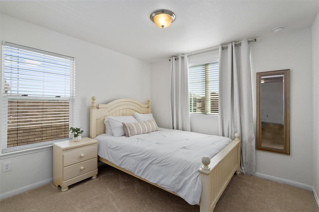 10308 Hatton Lane Austin, TX 78754 - Photo 18 of 25 Secondary bedroom with natural light, plush carpeting, and neutral tones
