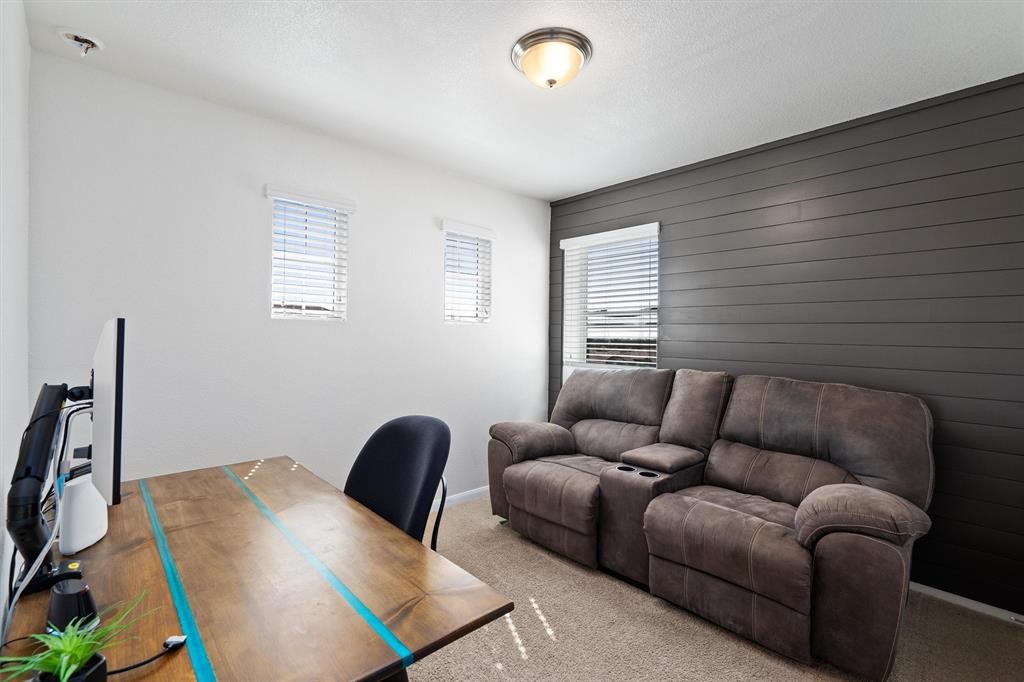 10308 Hatton Lane Austin, TX 78754 - Photo 20 of 25 Third bedroom ideal for a home office, guest room, or flex space, featuring natural light and neutral finishes