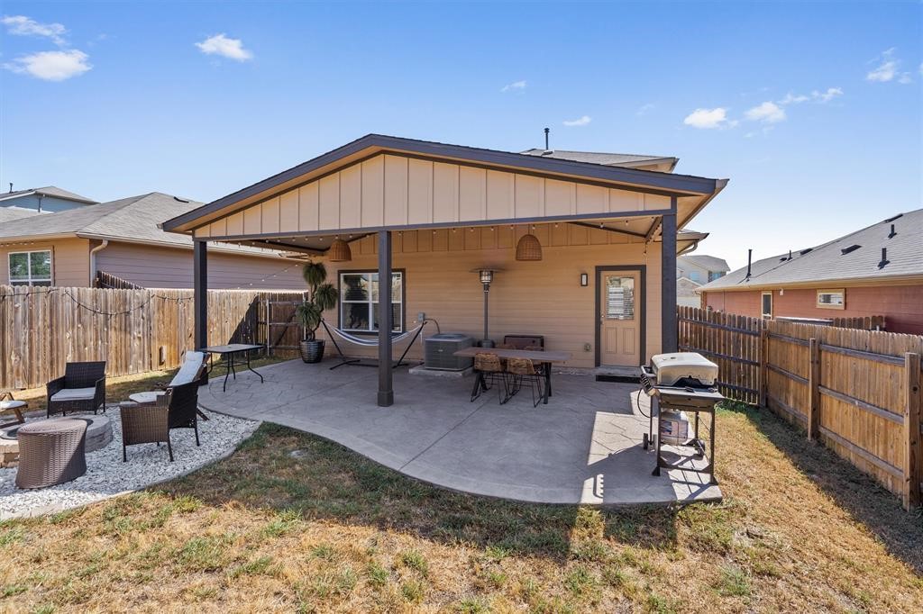 10308 Hatton Lane Austin, TX 78754 - Photo 22 of 25 Well-designed backyard featuring a large covered patio, grilling area, and fenced yard for privacy