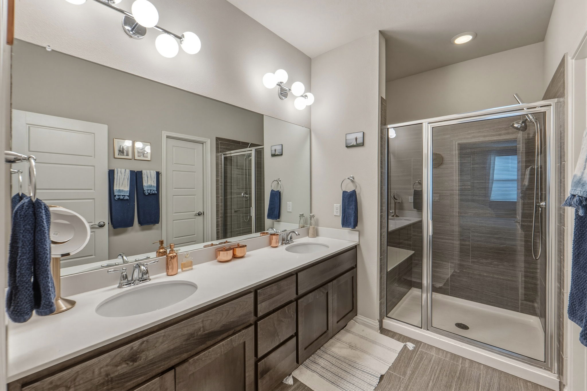 6814 East Riverside Drive, Unit 34 Austin, TX 78741 - Photo 19 of 26 a bathroom with a double vanity sink mirror and shower