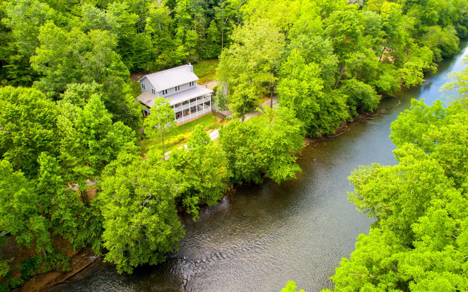 320 Hiawassee River Road Murphy, NC 28906 - Photo 1 of 4 an aerial view of a house with a yard and garden
