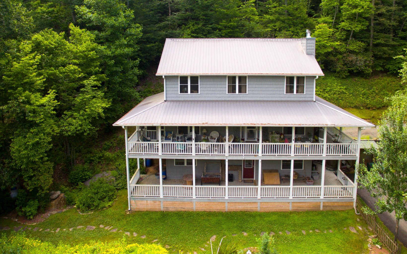 320 Hiawassee River Road Murphy, NC 28906 - Photo 2 of 4 a view of a white house with a large windows and a yard