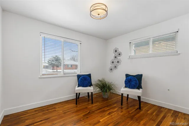 a view of a livingroom with furniture wooden floor and a window