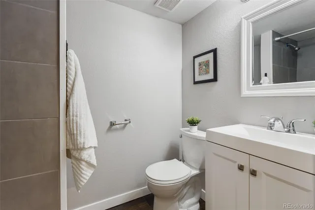 a bathroom with a sink toilet and a mirror