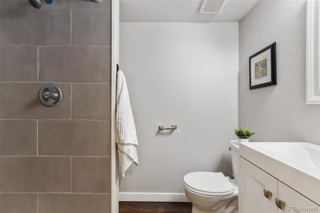 a bathroom with a toilet and a shower