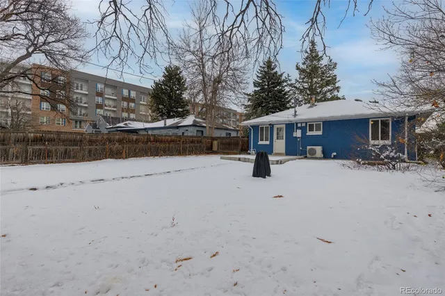 a view of house with a yard covered in snow