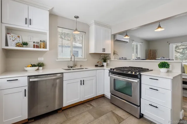 a kitchen with granite countertop cabinets stainless steel appliances and a sink