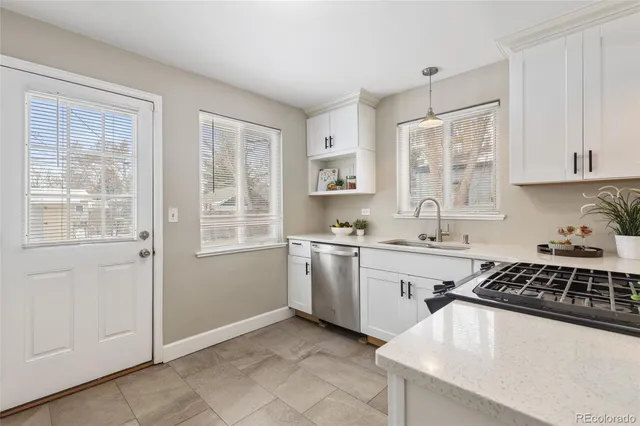 a kitchen with a sink stove and cabinets