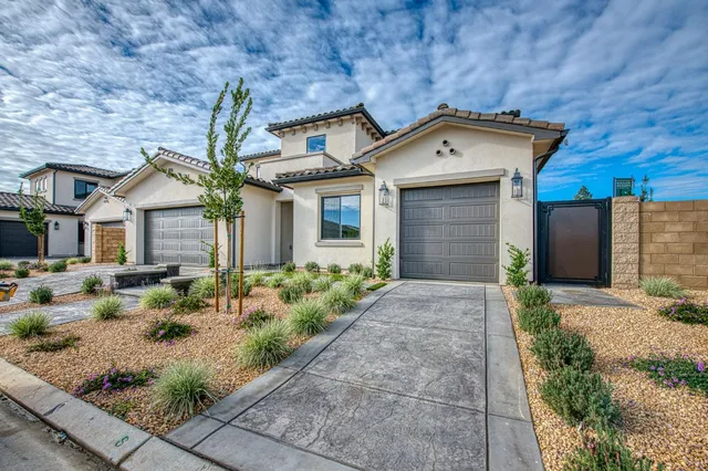 a front view of a house with garden