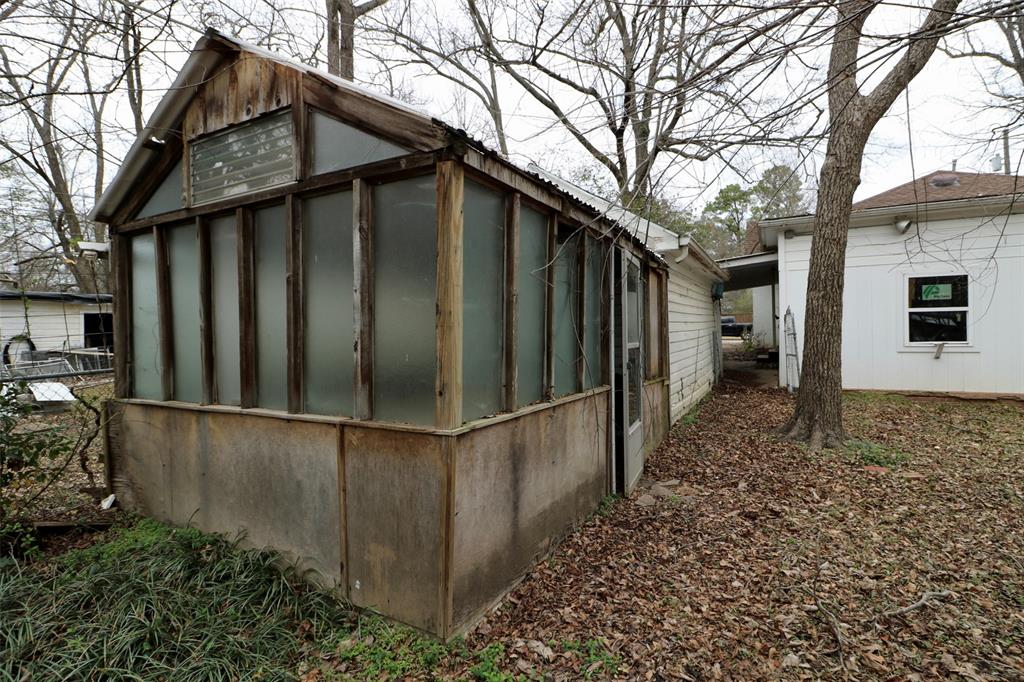 2332 Simpson Street Paris, TX 75460 - Photo 9 of 16 a backyard of a house with wooden fence and large trees