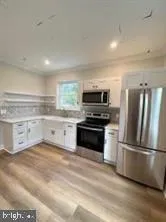 a kitchen with a refrigerator stove and microwave