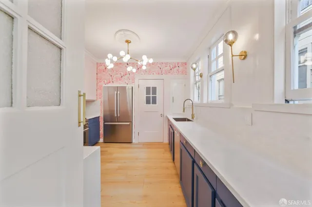 a kitchen with a sink and refrigerator
