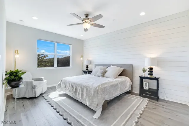 a bedroom with a large bed and a chandelier