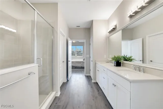 a bathroom with a double vanity sink and mirror