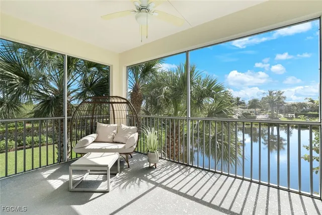 a balcony with wooden floor table and chairs