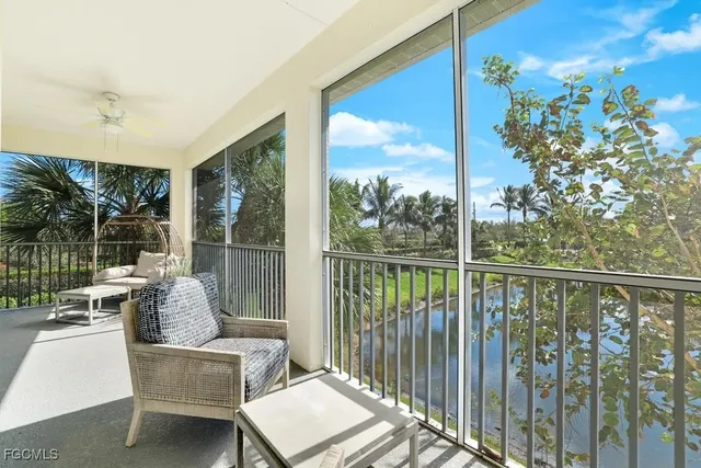 a balcony with furniture and a potted plant