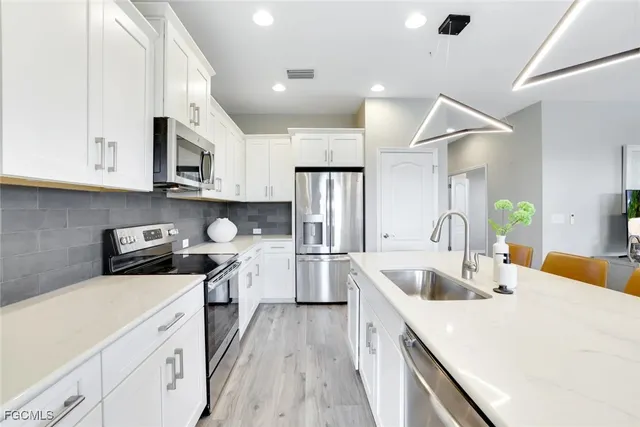 a kitchen with a sink stove and refrigerator