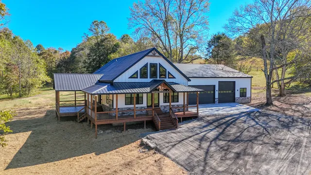 a front view of a house with a yard table and chairs