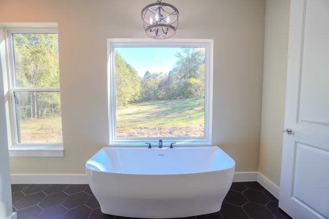 a bath tub sitting in a bathroom next to a window