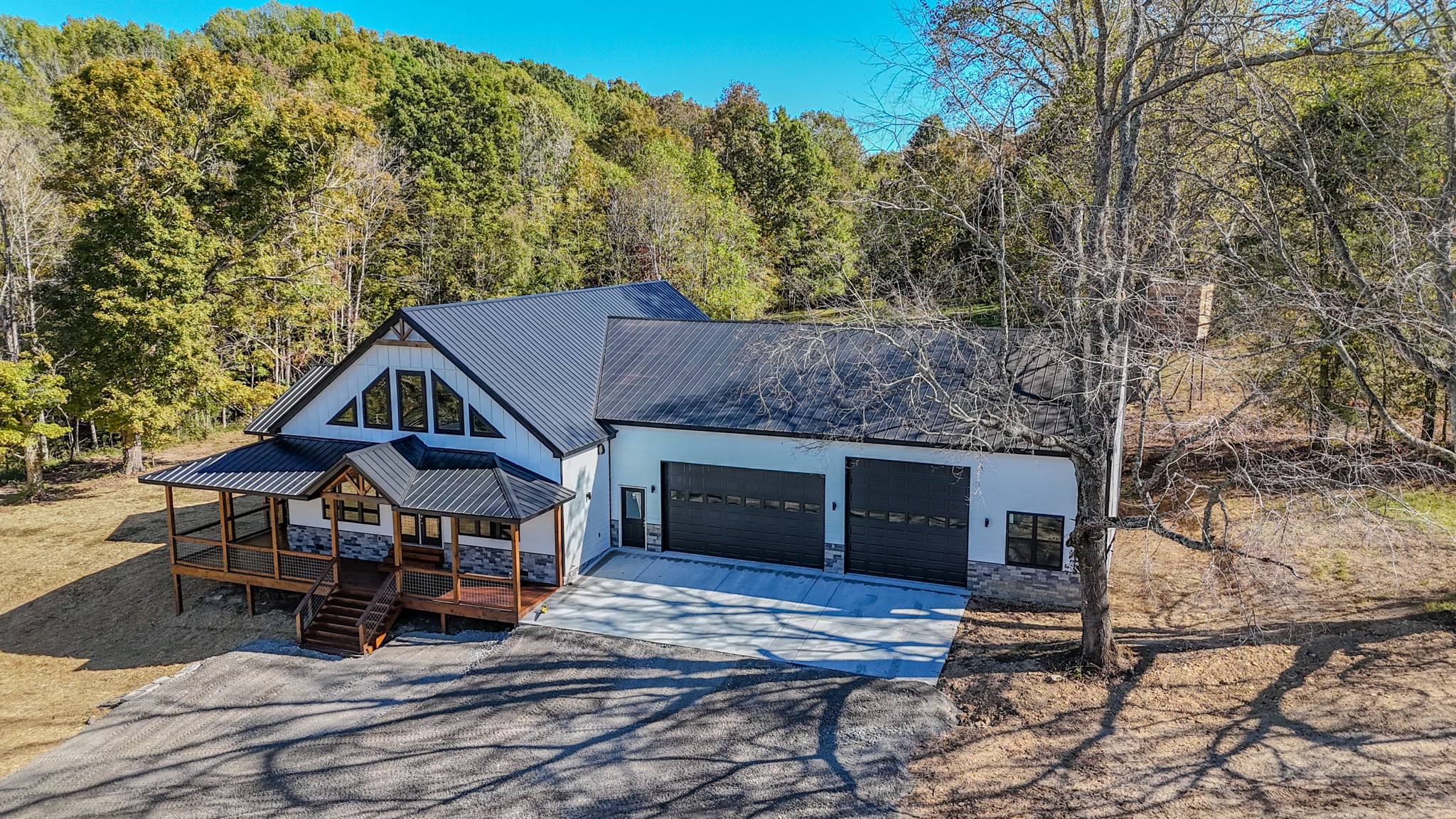 5109 Union Camp Road Lafayette, TN 37083 - Photo 21 of 36 a view of a house with wooden deck and furniture