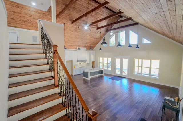 a kitchen with a sink and wooden floor