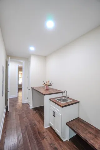 a view of a room with wooden floor and shelf