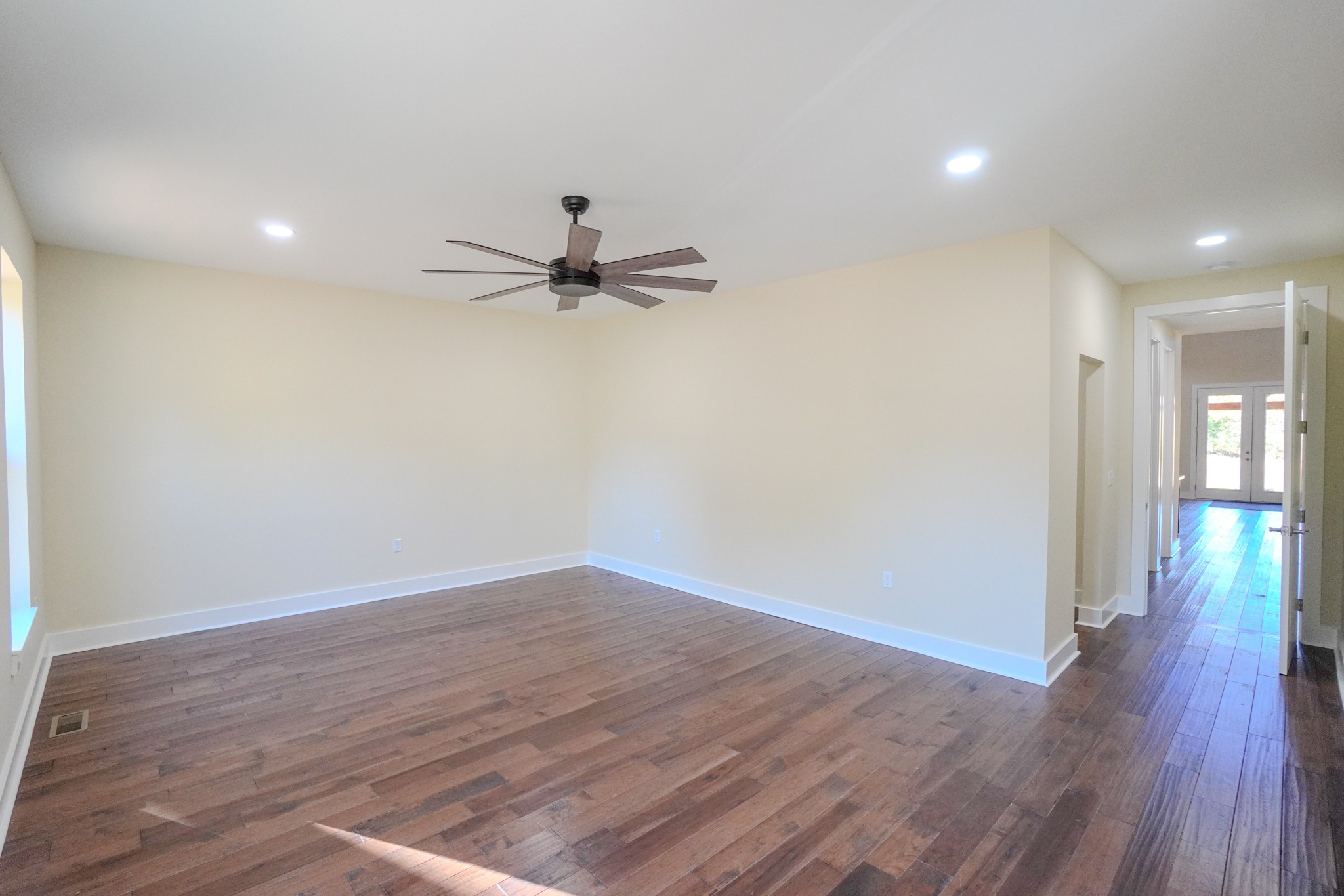 5109 Union Camp Road Lafayette, TN 37083 - Photo 7 of 36 a view of a room with wooden floor and a ceiling fan