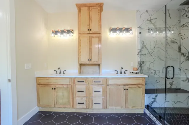 a bathroom with a sink a toilet and shower