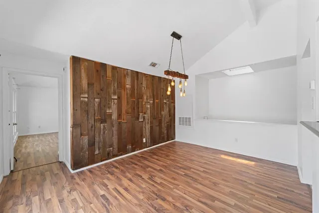a view of a room with wooden floor