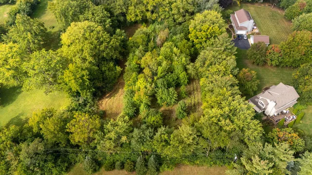 an aerial view of residential house with swimming pool and lawn chairs