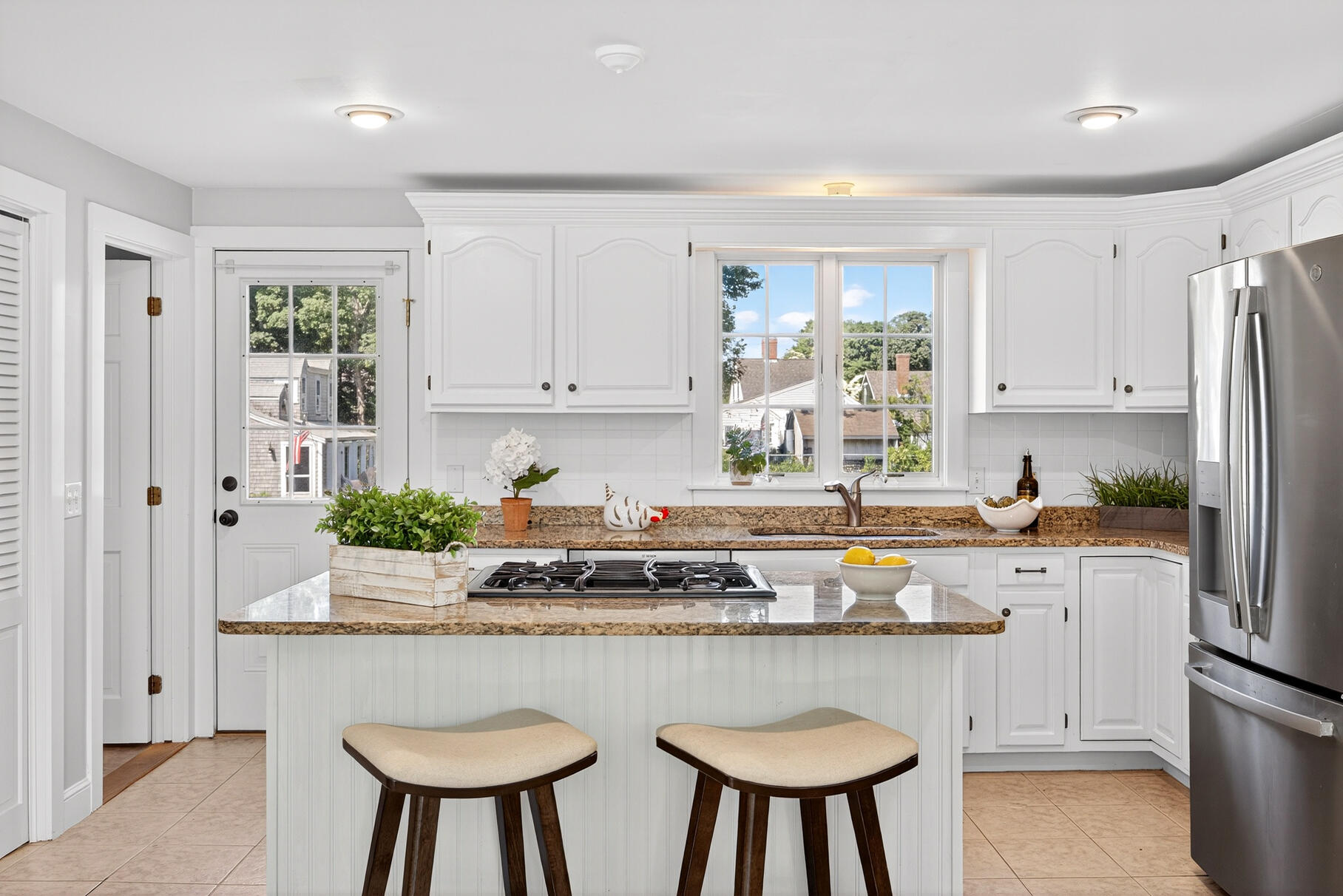 5 Canary Street Sandwich, MA 02563 - Photo 23 of 45 a kitchen with stainless steel appliances granite countertop a kitchen island hardwood floor sink stove and white cabinets