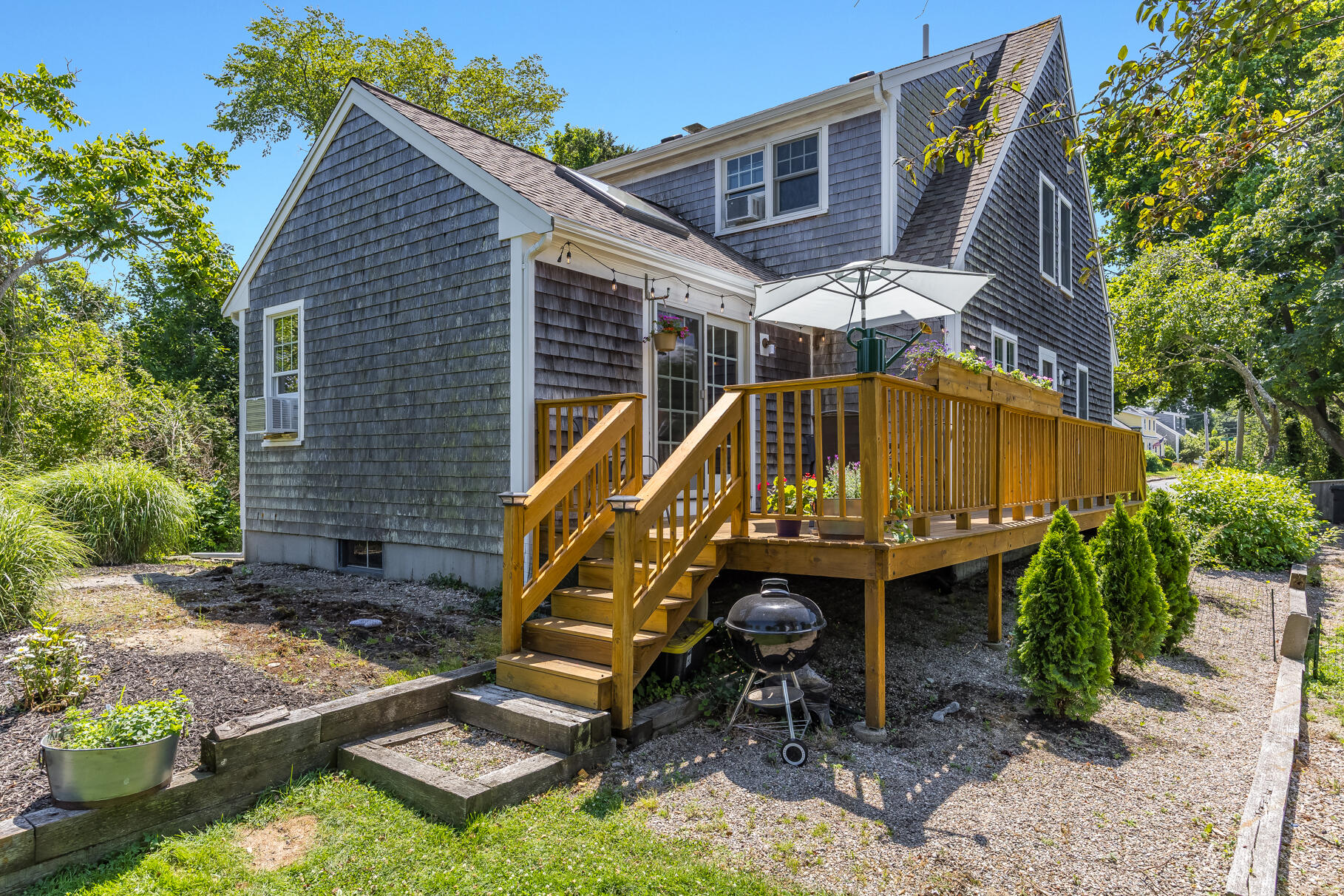 5 Canary Street Sandwich, MA 02563 - Photo 3 of 45 a view of backyard with a table and chairs