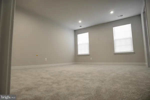 a bathroom with a double vanity sink toilet and mirror