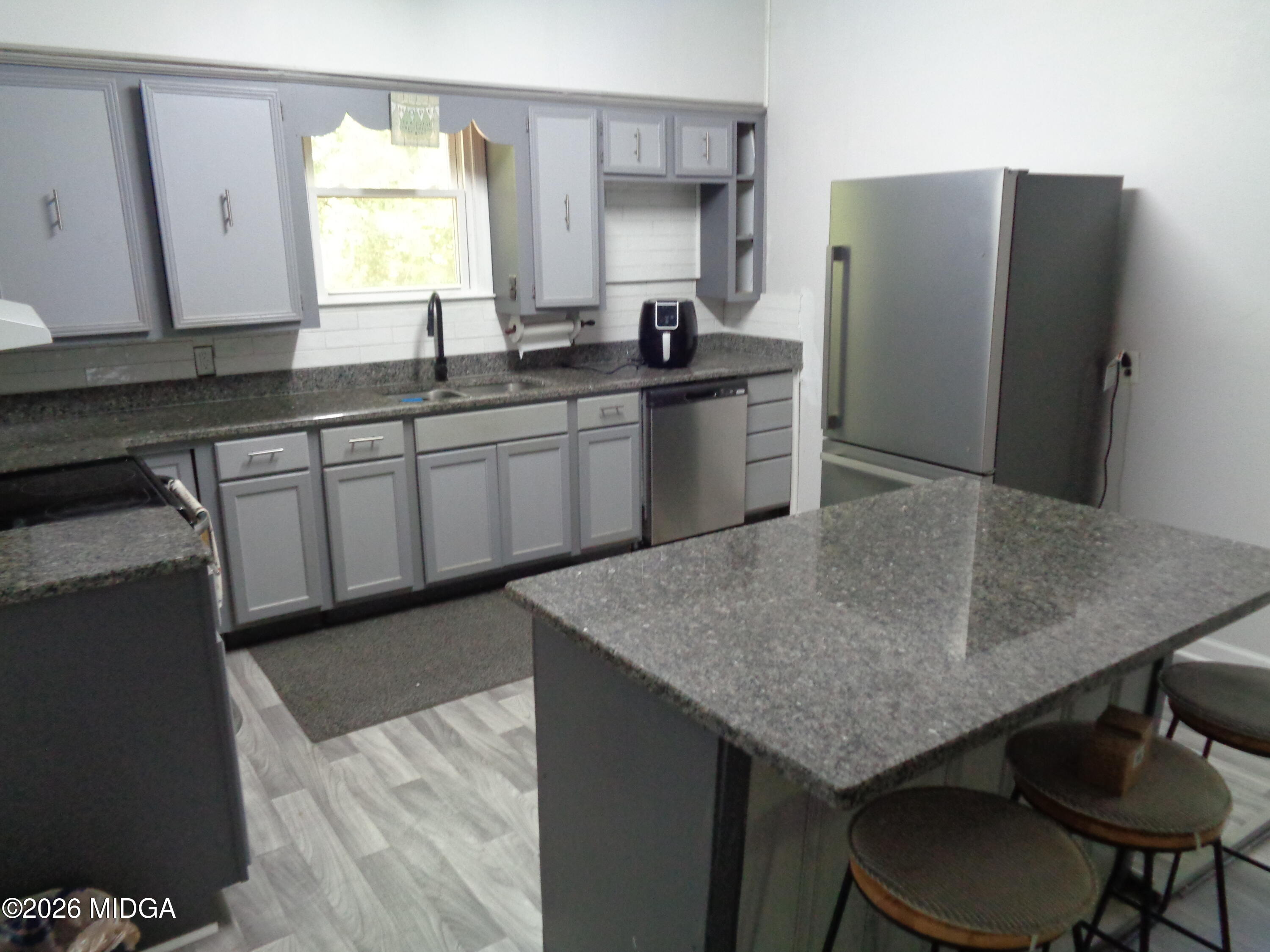 3380 Goodwin Lane Macon, GA 31217 - Photo 8 of 22 a kitchen with stainless steel appliances granite countertop a sink a refrigerator and a stove