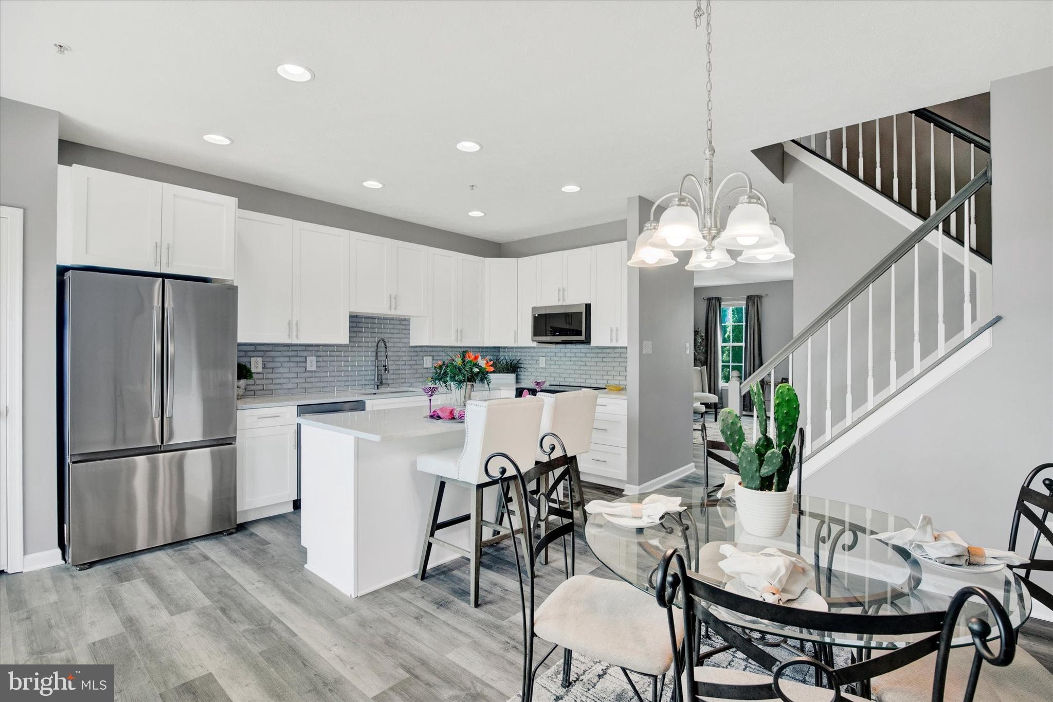 835 Lowe Road Middle River, MD 21220 - Photo 3 of 26 a kitchen with stainless steel appliances kitchen island a table and chairs in it