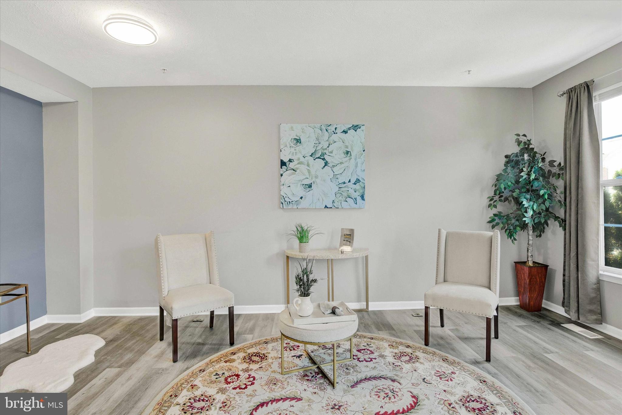 835 Lowe Road Middle River, MD 21220 - Photo 9 of 26 a living room with furniture and a potted plant
