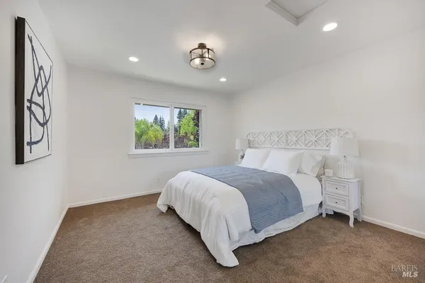 a bed room with a bed and a window
