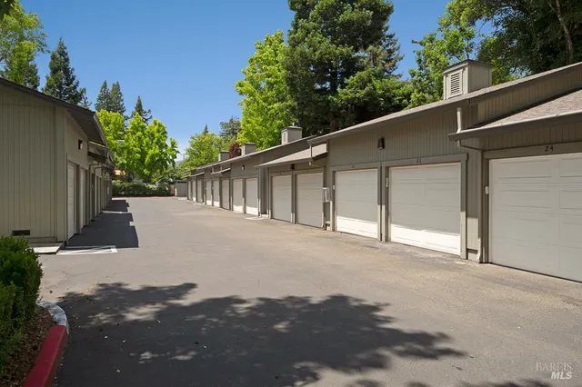 a view of a house with a backyard and road