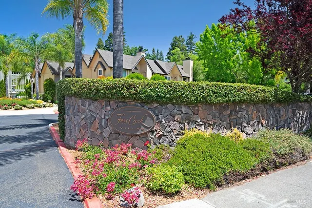 front view of a house with a yard and potted plants
